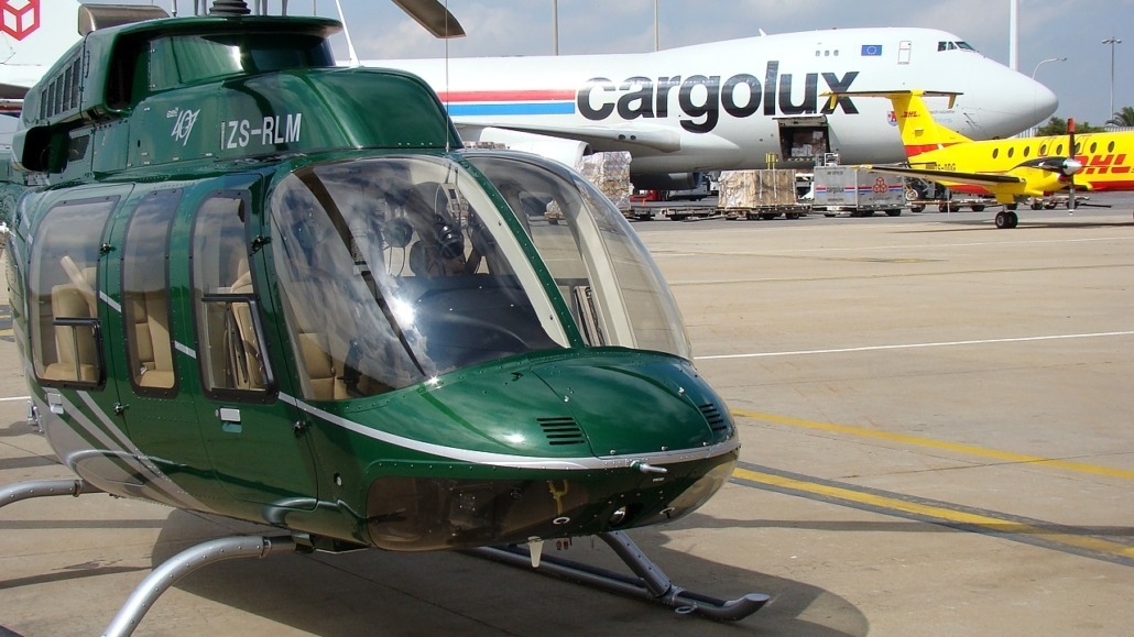 Bell 407 ZS-RLM at the cargo ramp at OR Tambo International